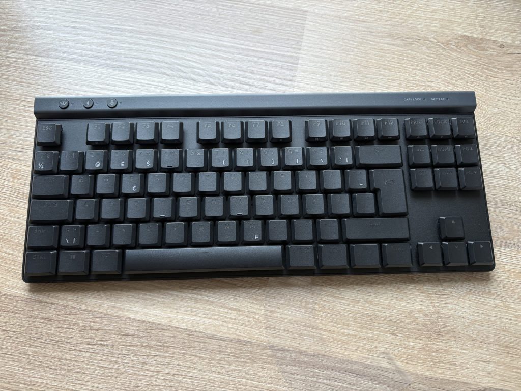 a black keyboard on a wood surface