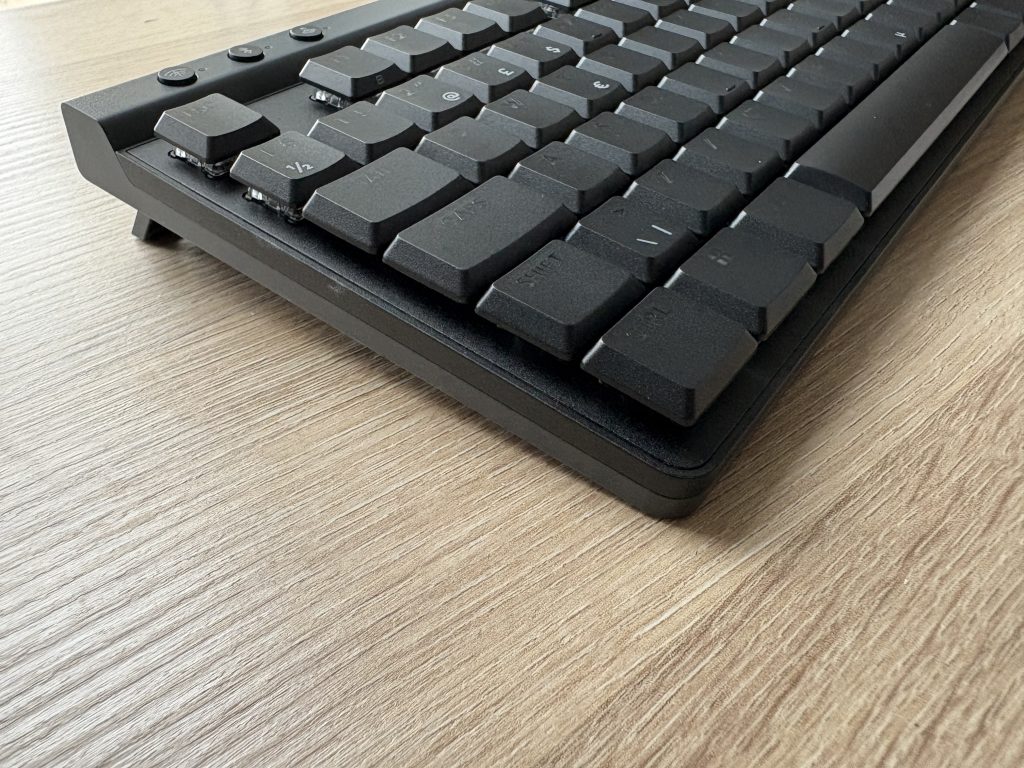 a black keyboard on a wood surface